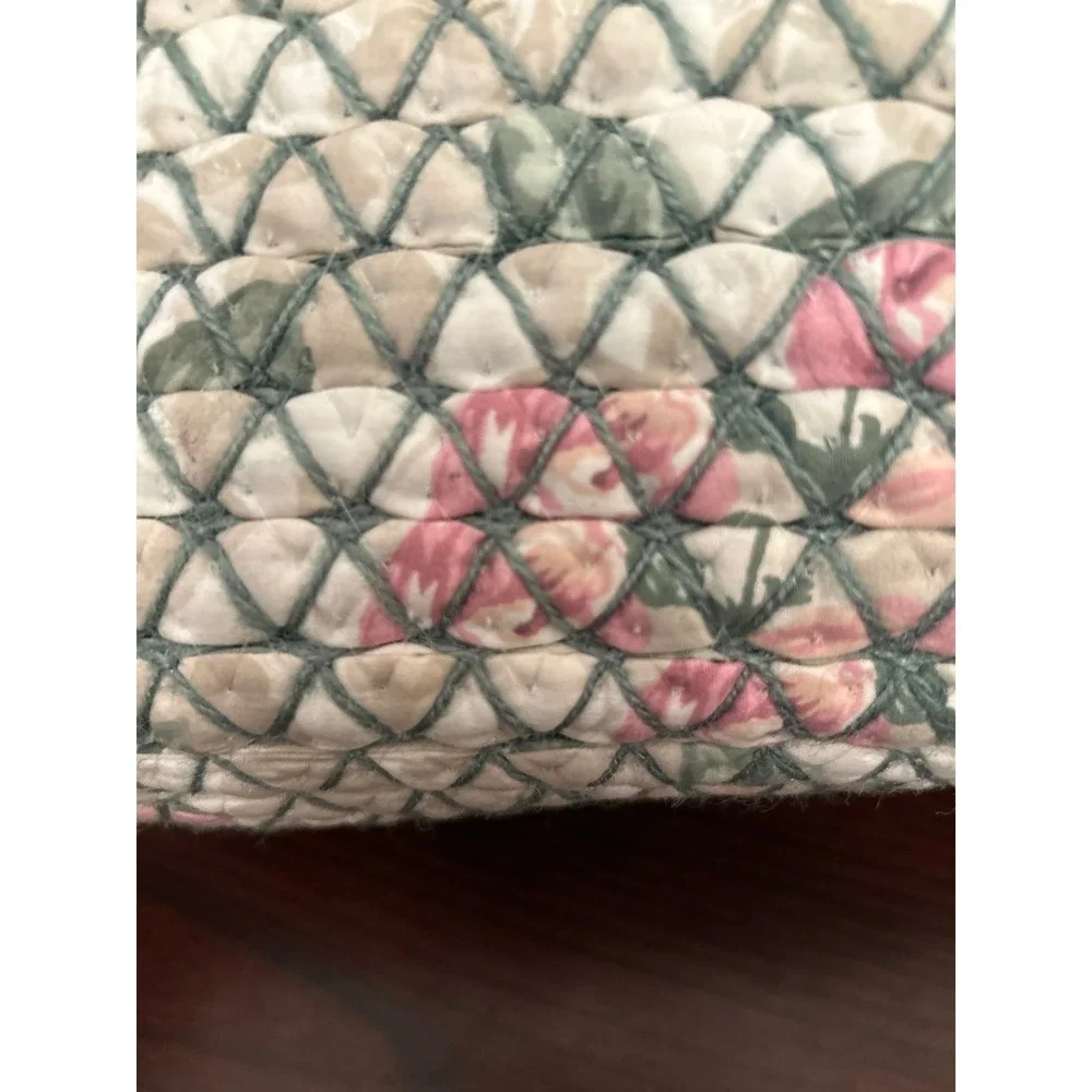 vintage oval rag rug basket features a braided, quilted design in green and pink